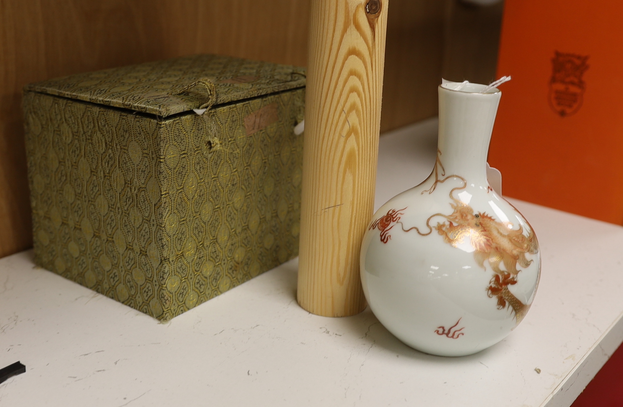 A Chinese rouge de fer decorated ‘dragon’ bottle vase, 14cm high (boxed)